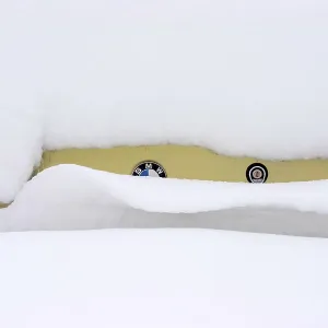 A BMW oldtimer completely covered in snow A BMW oldtimer completely covered in snow