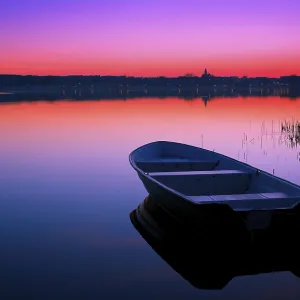 Boat in the background of the lake at a beautiful sunset Boat in the background of the lake at a beautiful sunset