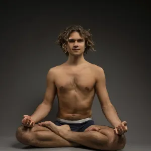 Full body shirtless young man in boxer briefs sitting in Lotus pose Full body shirtless young man in boxer briefs sitting in Lotus pose