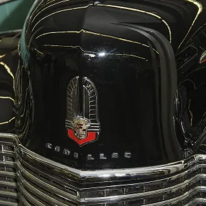 Bonnet with old historic logo underneath radiator grille of vintage classic car historic Cadillac