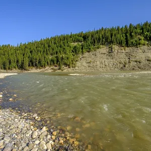 The Bow River erodes a steep embankment as it flows past the cobble riverbank at McKinnon Flats southeast of Calgary The Bow River erodes a steep embankment as it flows past the cobble riverbank at McKinnon Flats southeast of Calgary