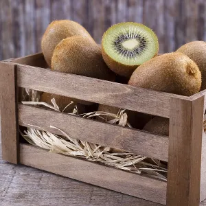 Box of fresh kiwi in on wooden background Box of fresh kiwi in on wooden background