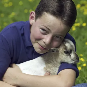 Boy holding a young pygmy goat