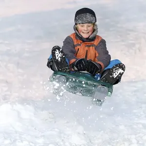Boy jumping with a sledge