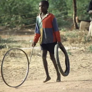 Boy playing with tires, Salima Boy playing with tires, Salima