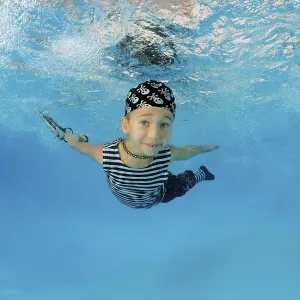 Boy presenting underwater fashion in pool Boy presenting underwater fashion in pool