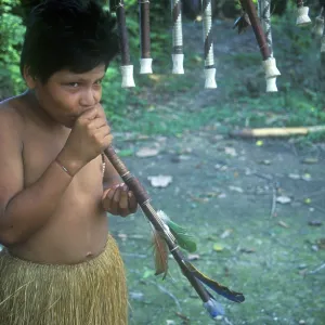 Boy from a Yagua tribe near Iquitos showing blowpipe made for tourists Boy from a Yagua tribe near Iquitos showing blowpipe made for tourists