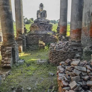 Brick columns of a dilapidated temple with Buddha figure in Amarapura