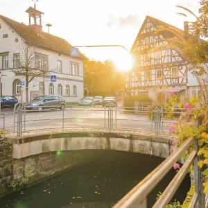 Bridge over a river, half-timbered buildings at sunset Bridge over a river, half-timbered buildings at sunset