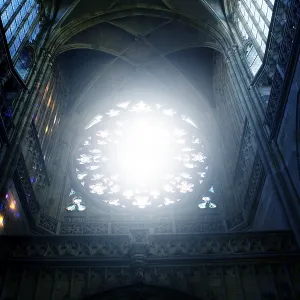 Bright light streaming through a rose window in a gothic cathedral