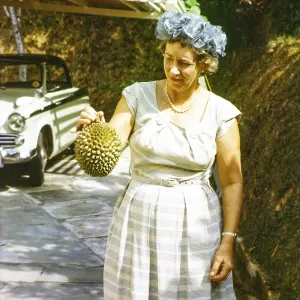 British expatriate woman holding a durian fruit
