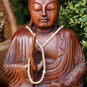 Buddha figure wearing a necklace at a garden exhibition