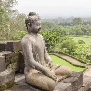 Buddha sculpture at a temple named Borobudur located in Java Buddha sculpture at a temple named Borobudur located in Java