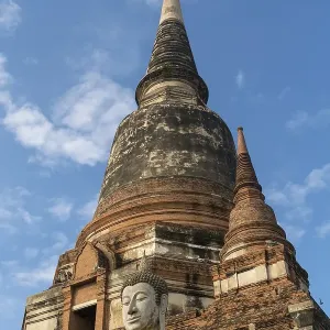 Buddha statue in front of large Chedi