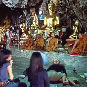 Buddha statue, monks and believers praying Buddha statue, monks and believers praying
