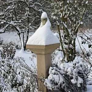 Buddha statue on a pillar has put on a snow coat Buddha statue on a pillar has put on a snow coat