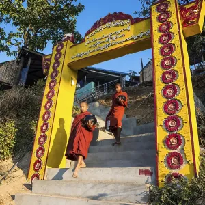 Buddhist novices with begging bowls at their morning begging tour Buddhist novices with begging bowls at their morning begging tour