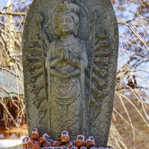 Buddhist statue decorated with Daruma figures