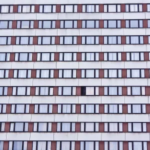 Building facade with a grid of windows creating a repetitive pattern