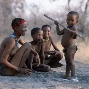 Bushman woman with children, child plays with stick Bushman woman with children, child plays with stick