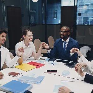 Businessman and businesswoman team meditate and holds hands each other after office meeting Businessman and businesswoman team meditate and holds hands each other after office meeting
