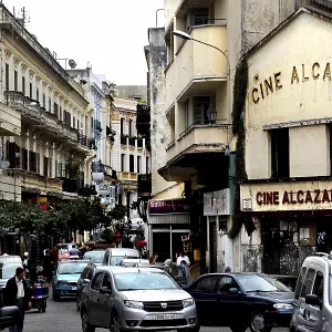 Bustling street scene in the Medina of Tangier with the Alcazar cinema