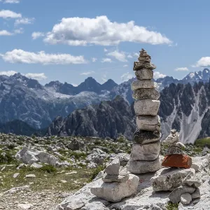 Cairns in front of an impressive Alpine panorama
