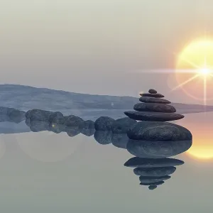 Calm lake beach with stacked stones Calm lake beach with stacked stones