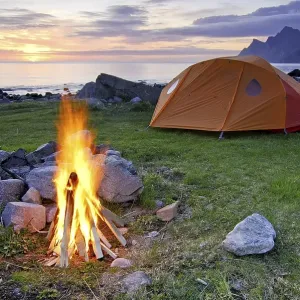 Campfire with tent, midnight sun Campfire with tent, midnight sun