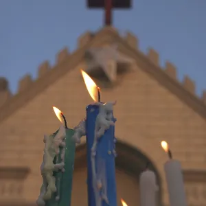 Candles melted burning against St
