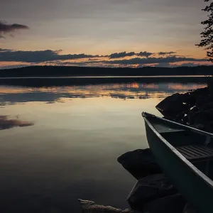 Canoe on shore at sunset, Lake Vaekkaeraejaervi Canoe on shore at sunset, Lake Vaekkaeraejaervi