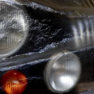 Car Lamps on the Front of a an Old Classic Car Covered with Plastic Protection in Switzerland Car Lamps on the Front of a an Old Classic Car Covered with Plastic Protection in Switzerland