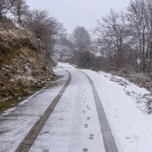 Car tracks on the road to mount aizkorri in gipuzkoa Car tracks on the road to mount aizkorri in gipuzkoa