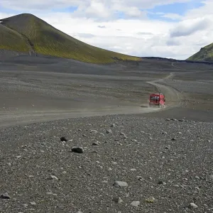 Caravan on dirt road in barren volcanic landscape Caravan on dirt road in barren volcanic landscape