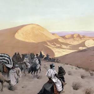 Caravan on the way through the dunes of the Sahara