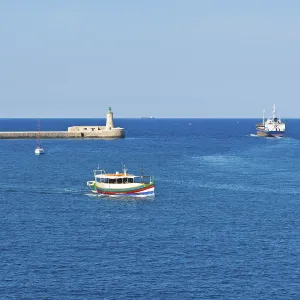 Cargo ship leaves the harbor of Valletta Cargo ship leaves the harbor of Valletta