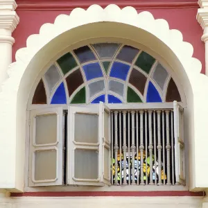 Carved window with stained glass Goa Maharashtra India Asia September 2010 Carved window with stained glass Goa Maharashtra India Asia September 2010