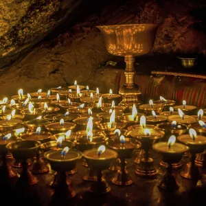 Cave with candles and Buddha images along the Kailash Kora Cave with candles and Buddha images along the Kailash Kora