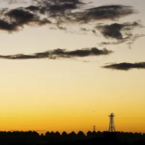 Cell phone station and city skyline under sunset