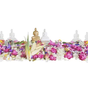 Ceremonial flowers and buddha figurines isolated on white background