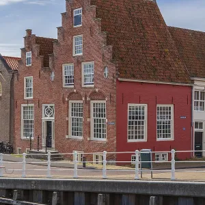 Charming red half-timbered house on the waterfront with historic architecture