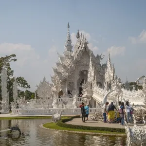 Chiang Rai, Thailand - Feb 2016: Tourists visiting famous Chiang Rai White Temple - Wat Rong Khun on a sunny day