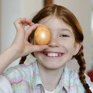 Child, girl holding a coloured Easter egg Child, girl holding a coloured Easter egg