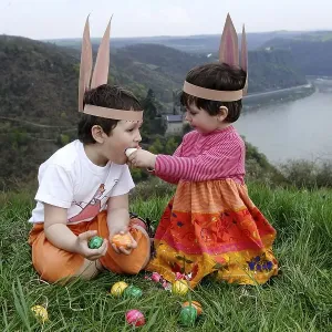 Children looking for Easter eggs at the Rhine River above the Loreley rocks Children looking for Easter eggs at the Rhine River above the Loreley rocks