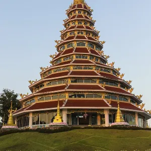 Children playing in front of the nine-story pagoda of the Wat Huay Pla Kang temple Children playing in front of the nine-story pagoda of the Wat Huay Pla Kang temple