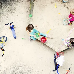 Children playing in the sandbox of a backyard Children playing in the sandbox of a backyard