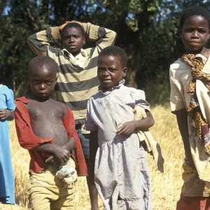 Children posing for the camera on the side of the road Children posing for the camera on the side of the road