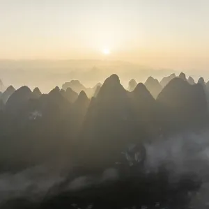 Chinese karst mountains at the Yangshuo River at sunrise Chinese karst mountains at the Yangshuo River at sunrise