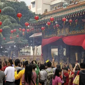Chinese New Year ceremony with incense sticks in front of the buddhist Kwam Im Tong Hood Che temple in Singapore Chinese New Year ceremony with incense sticks in front of the buddhist Kwam Im Tong Hood Che temple in Singapore