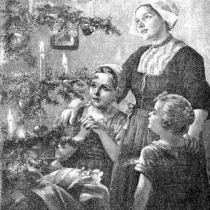 Christmas time, mother and two children in front of Christmas tree with burning candles Christmas time, mother and two children in front of Christmas tree with burning candles